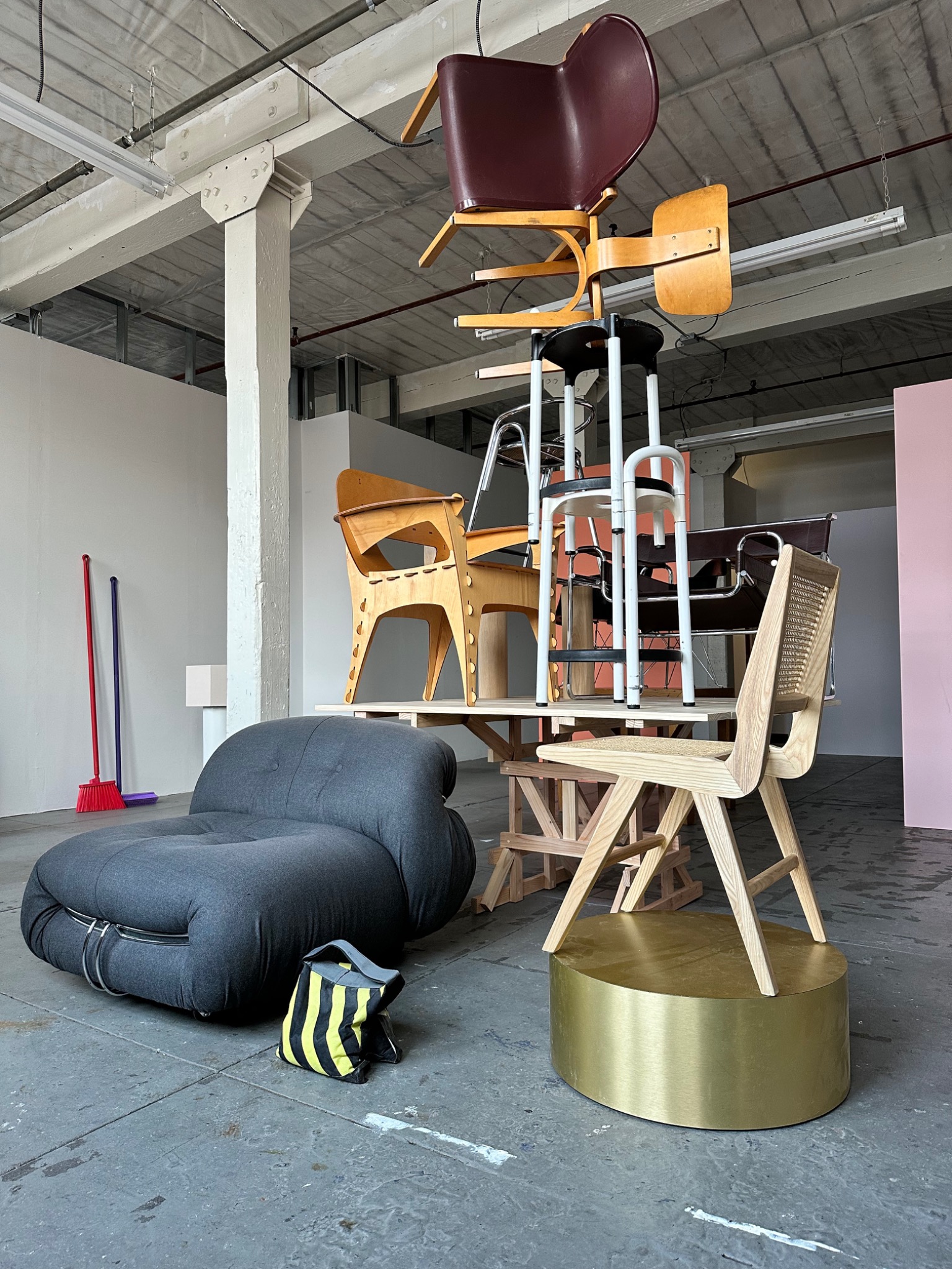 Furniture and chairs arranged in a sculptural studio installation