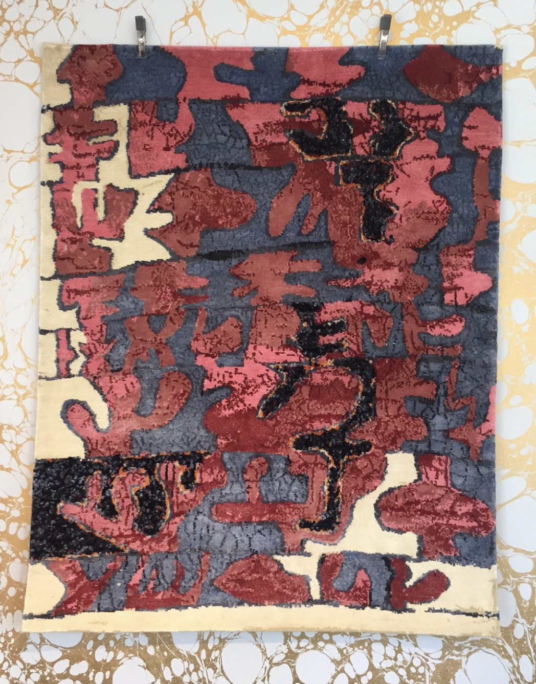 Red, charcoal, black, and cream textile artwork by Josh Elrod