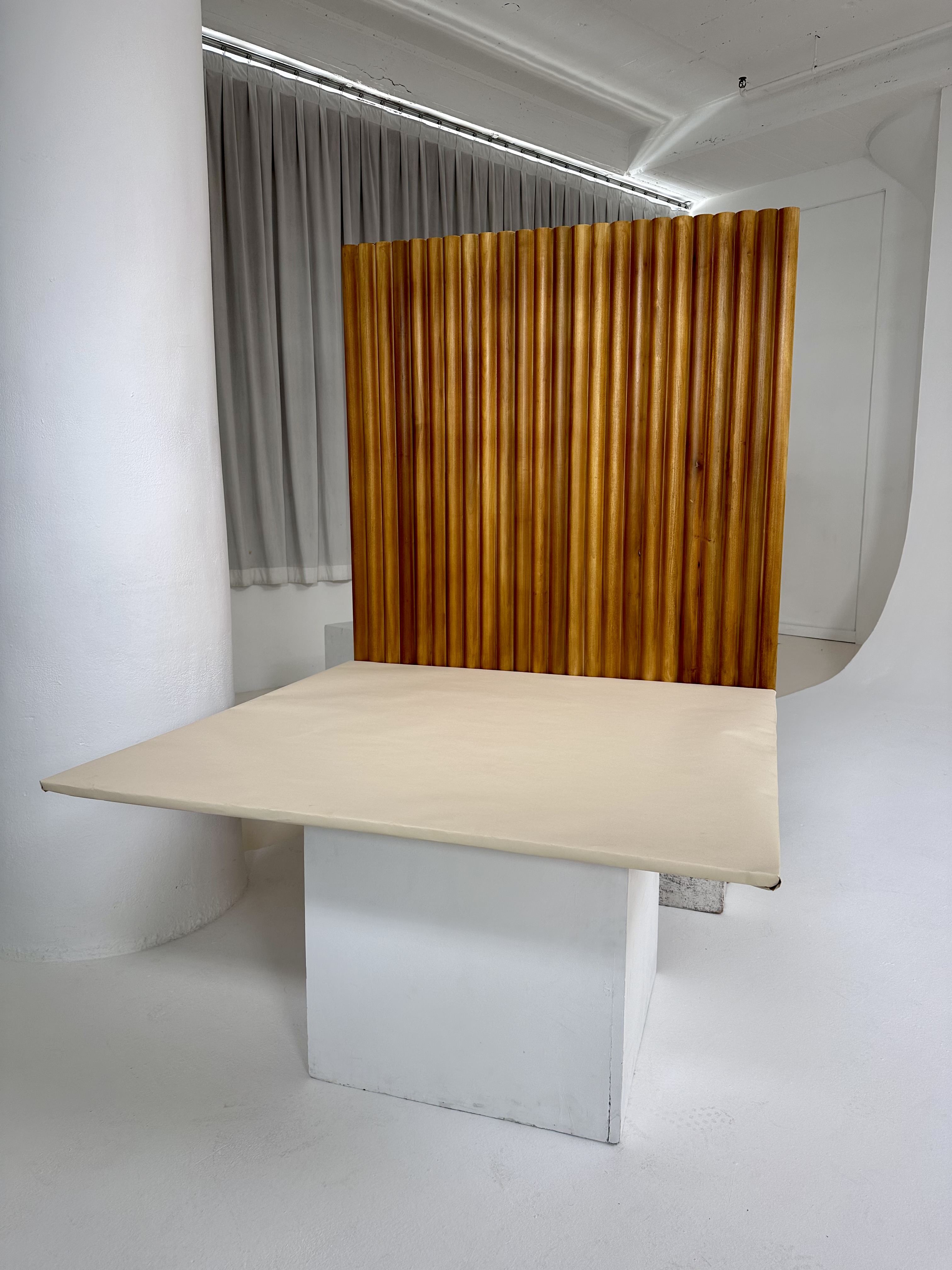 Custom table and fluted wood partition in a white studio space